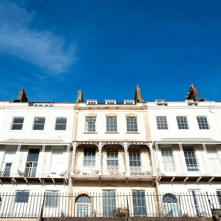 The front of white terrace buildings with ornate metal work situated in Royal York Crescent in Clifton, Bristol