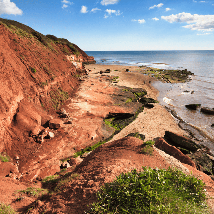 Red rock coastal cliffs in Devon on a sunny day