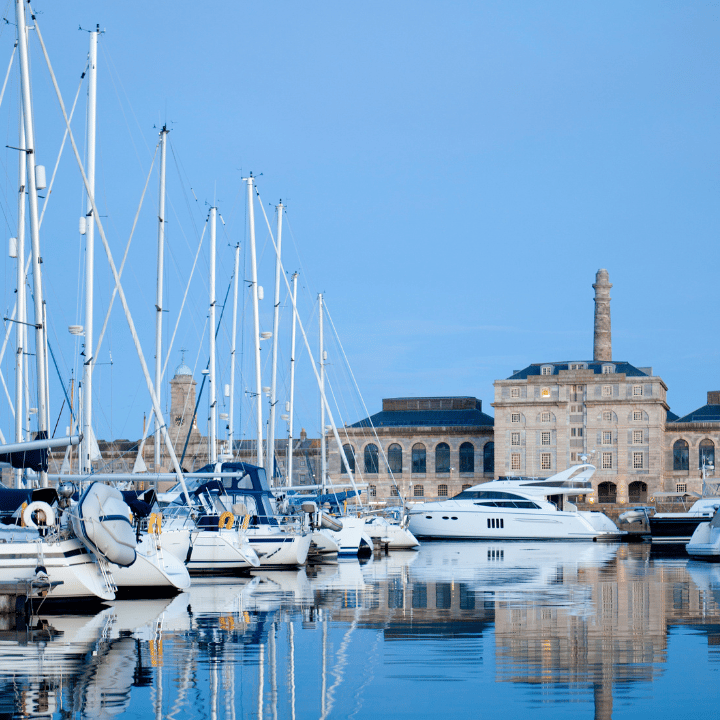 Boats moored in Royal William Yard Marina with old naval buildings