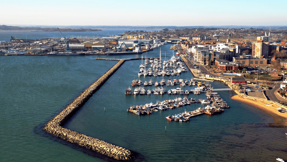 Poole Harbour with a range of boats docked and buildings in the background