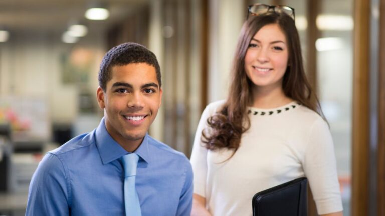 Two smartly dressed young professionals in an office